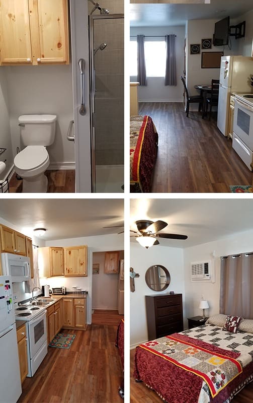 A small apartment with wood furnishings. Includes a bathroom with shower, a kitchen with appliances and dining table, and a bedroom with a bed, dresser, and ceiling fan. Wood flooring throughout.